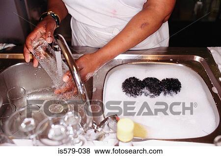 Cleaning glass in kitchen sink View Large Photo Image Stock Photo - Cleaning glass in kitchen sink. Fotosearch