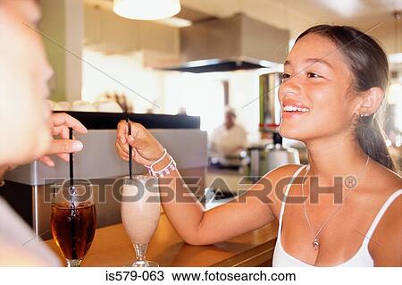 Couple with drinks at the bar View Large Photo Image Stock Image - Couple with drinks at the bar. Fotosearch