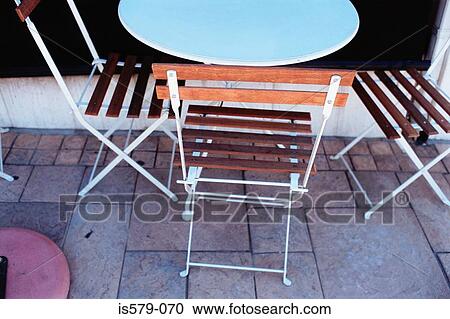 Empty chairs and table outside View Large Photo Image Stock Image - Empty chairs and table outside. Fotosearch