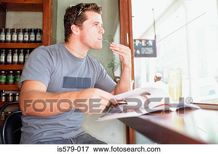 Man sitting at cafe window View Large Photo Image Stock Photo - Man sitting at cafe window. Fotosearch