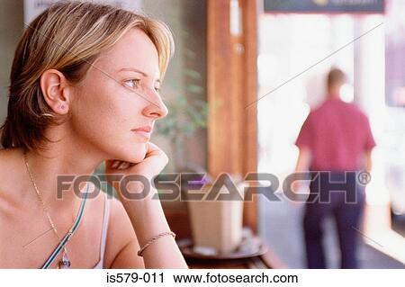 Wistful young woman in cafe View Large Photo Image Stock Image - Wistful young woman in cafe. Fotosearch