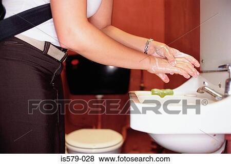 Woman soaping hands in basin View Large Photo Image Stock Photo - Woman soaping hands in basin. Fotosearch