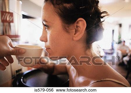 Young woman having a coffee View Large Photo Image Stock Photograph - Young woman having a coffee. Fotosearch