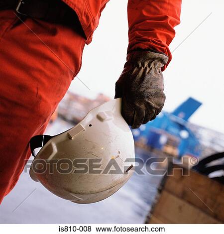 Construction worker holding hard hat View Large Photo Image Stock Photo - Construction worker holding hard hat. Fotosearch