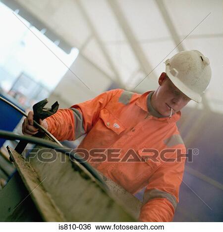 Construction worker holding spanner View Large Photo Image Stock Photograph - Construction worker holding spanner. Fotosearch