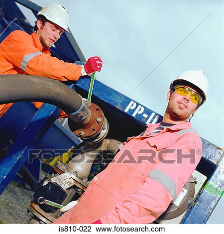 Construction workers adjusting pipe View Large Photo Image Stock Image - Construction workers adjusting pipe. Fotosearch