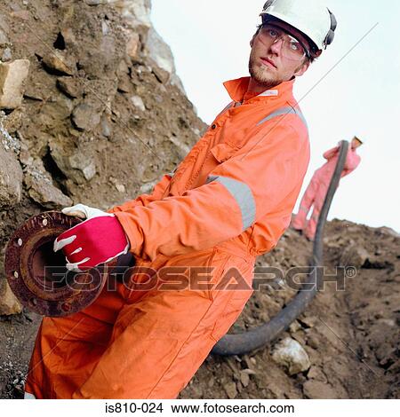 Construction workers carrying a pipe View Large Photo Image Picture - Construction workers carrying a pipe. Fotosearch