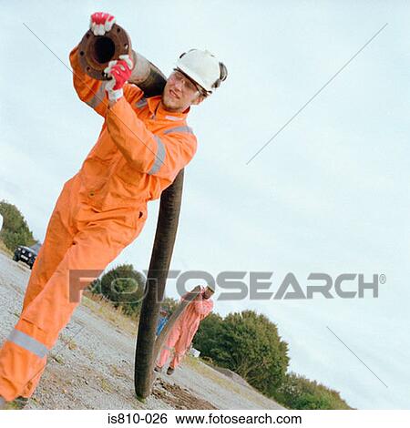 Construction workers carrying a pipe View Large Photo Image Stock Photograph - Construction workers carrying a pipe. Fotosearch