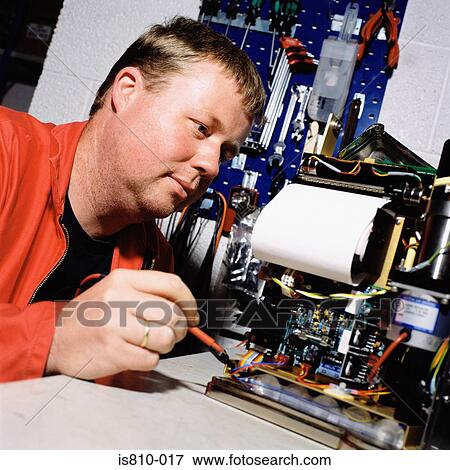 Electrician working on machine View Large Photo Image Stock Photo - Electrician working on machine. Fotosearch