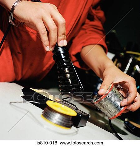 Stock Photo - Electrician working on machinery. Fotosearch