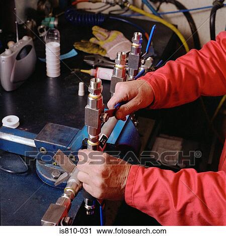Engineer adjusting machinery View Large Photo Image Stock Image - Engineer adjusting machinery. Fotosearch