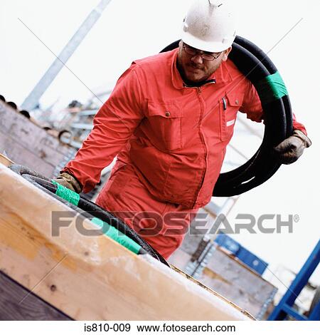 Engineer holding pipe View Large Photo Image Stock Photo - Engineer holding pipe. Fotosearch