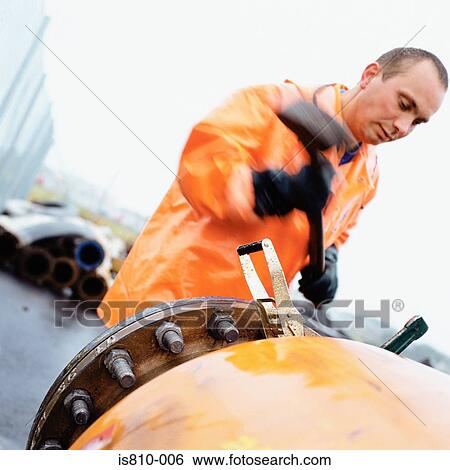 Engineer using a mallet View Large Photo Image Stock Photograph - Engineer using a mallet. Fotosearch