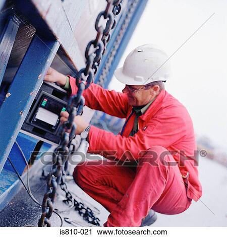 Engineer working on machine View Large Photo Image Stock Image - Engineer working on machine. Fotosearch