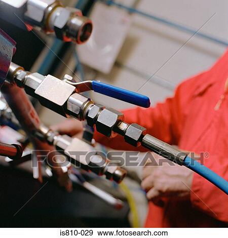 Stock Photo - Engineer working on machine. Fotosearch