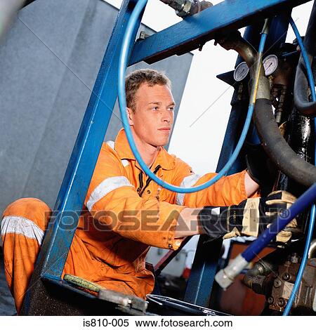 Stock Photography - Engineer working on machinery. Fotosearch