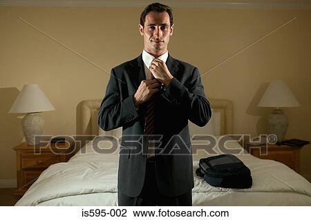 Businessman adjusting necktie View Large Photo Image Stock Image - Businessman adjusting necktie. Fotosearch
