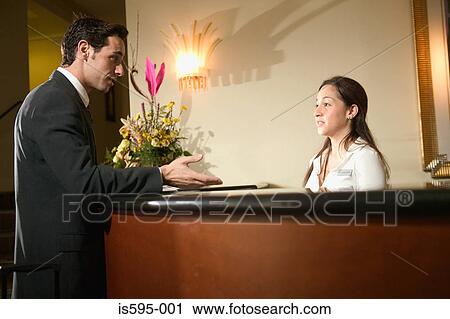 Businessman at hotel reception View Large Photo Image Stock Image - Businessman at hotel reception. Fotosearch