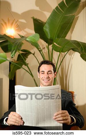 Stock Image - Businessman in hotel lobby. Fotosearch