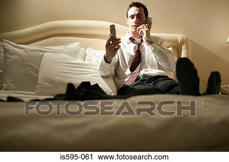Businessman using telephones View Large Photo Image Stock Image - Businessman using telephones. Fotosearch