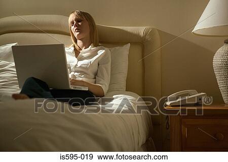 Stock Photo - Businesswoman using laptop computer. Fotosearch