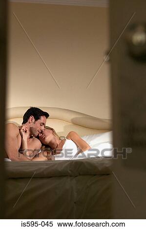 Couple kissing in bed View Large Photo Image Stock Photography - Couple kissing in bed. Fotosearch