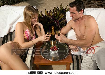 Stock Image - Couple toasting on honeymoon. Fotosearch