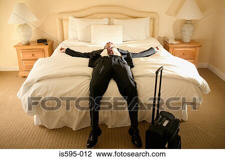 Exhausted businessman on bed View Large Photo Image Stock Image - Exhausted businessman on bed. Fotosearch