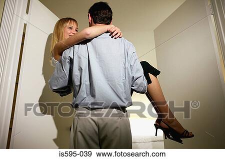 Man carrying wife through doorway View Large Photo Image Stock Photo - Man carrying wife through doorway. Fotosearch