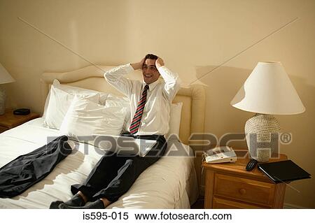 Relieved businessman in hotel room View Large Photo Image Stock Photography - Relieved businessman in hotel room. Fotosearch