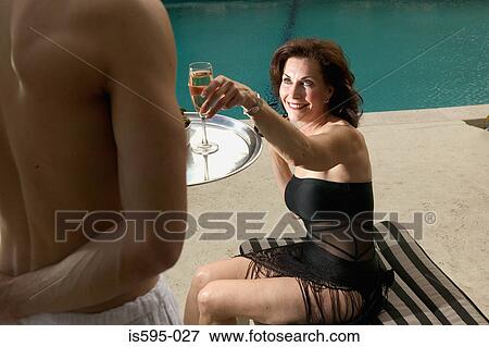Woman reaching for champagne flute View Large Photo Image Stock Photo - Woman reaching for champagne flute. Fotosearch
