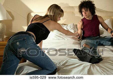 Stock Photo - Young couple in hotel room. Fotosearch