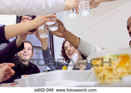 Friends eating fast food at table View Large Photo Image Stock Photo - Friends eating fast food at table. Fotosearch
