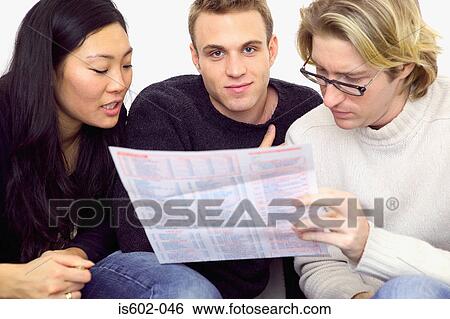 Friends looking at fast food menu View Large Photo Image Stock Photograph - Friends looking at fast food menu. Fotosearch