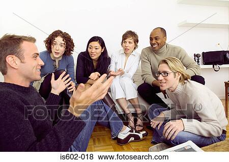 Friends talking in living room View Large Photo Image Stock Photo - Friends talking in living room. Fotosearch