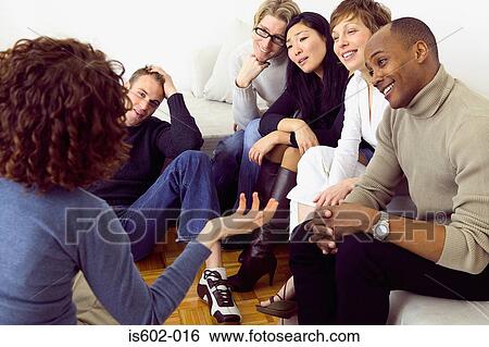 Friends talking in living room View Large Photo Image Stock Photograph - Friends talking in living room. Fotosearch