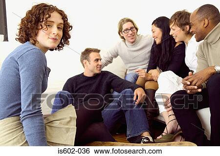 Friends talking in living room View Large Photo Image Stock Photograph - Friends talking in living room. Fotosearch