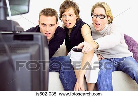 Stock Photography - Friends watching television. Fotosearch