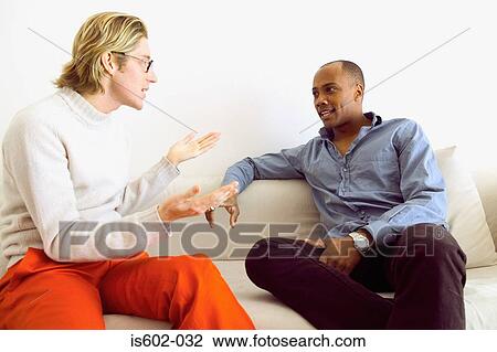 Stock Image - Men talking on sofa. Fotosearch