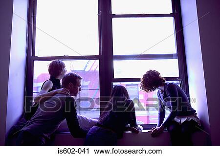 Silhouetted people at window View Large Photo Image Stock Image - Silhouetted people at window. Fotosearch