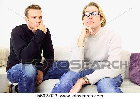 Thoughtful looking men on sofa View Large Photo Image Stock Image - Thoughtful looking men on sofa. Fotosearch
