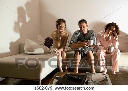 Tired people sitting on sofa View Large Photo Image Stock Photo - Tired people sitting on sofa. Fotosearch