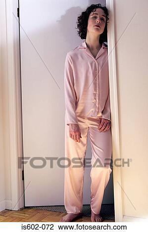 Tired woman standing in doorway View Large Photo Image Stock Image - Tired woman standing in doorway. Fotosearch