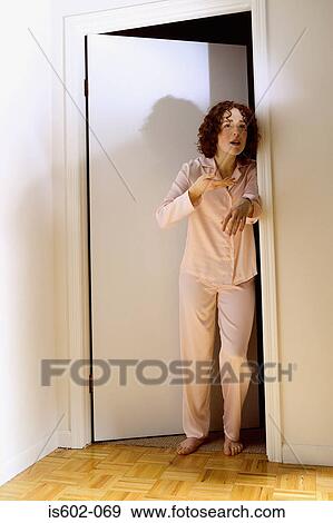 Tired woman standing in doorway View Large Photo Image Stock Photo - Tired woman standing in doorway. Fotosearch