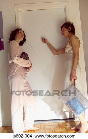 Women knocking on bedroom door View Large Photo Image Picture - Women knocking on bedroom door. Fotosearch