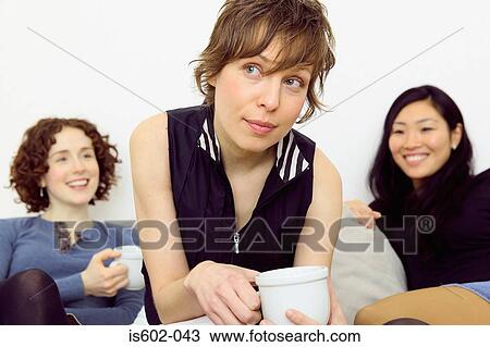Women sitting on sofa View Large Photo Image Stock Image - Women sitting on sofa. Fotosearch