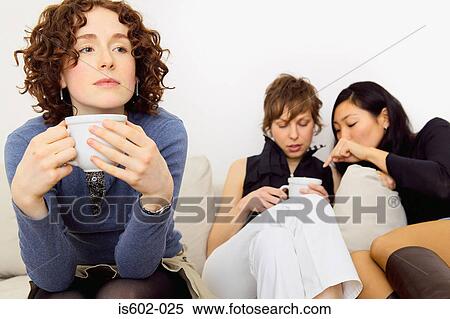 Stock Photography - Women sitting on sofa. Fotosearch