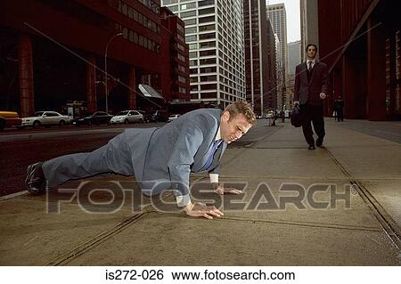 Businessman doing push ups in street View Large Photo Image Stock Photograph - Businessman doing push ups in street. Fotosearch