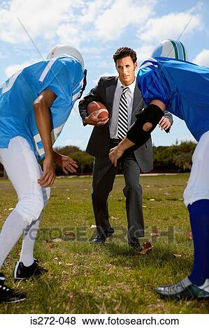 Businessman playing american football View Large Photo Image Stock Photo - Businessman playing american football. Fotosearch