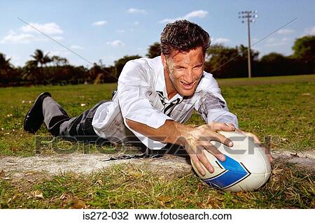 Businessman playing rugby View Large Photo Image Stock Image - Businessman playing rugby. Fotosearch